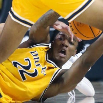 Delaware's Gianmarco Arletti (left) scrambles for a loose ball with Drexel's Amari Williams in the second half of Delaware's 58-54 loss at the Bob Carpenter Center, Wednesday, Feb. 8, 2023.

Ncaa Basketball Wil Hens Drexel Bball Drexel At Delaware