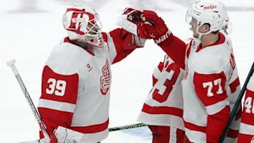 Nov 13, 2024; Pittsburgh, Pennsylvania, USA;  Detroit Red Wings goaltender Cam Talbot (39) and defenseman Simon Edvinsson (77) celebrate after defeating the Pittsburgh Penguins in overtime at PPG Paints Arena. Mandatory Credit: Charles LeClaire-Imagn Images