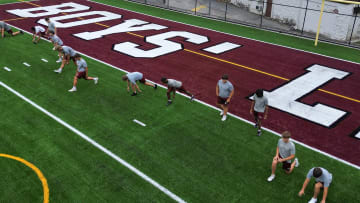 Boys' Latin football players go through a preseason workout on the newly turf surface on J. Duncan Smith Field.