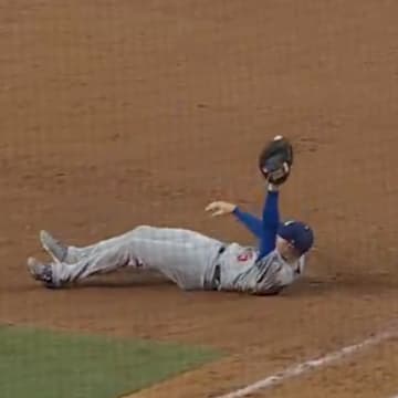 Freeman holds his glove in the air after securing the final out against the Royals