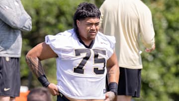 May 11, 2024; New Orleans, LA, USA;  New Orleans Saints offensive tackle Taliese Fuaga (75) looks on during the rookie minicamp at the Ochsner Sports Performance Center. Mandatory Credit: Stephen Lew-USA TODAY Sports