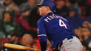 Texas Rangers designated hitter Joc Pederson (4) hits a ground rule double to drive in a run against the Boston Red Sox
