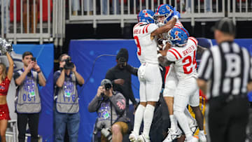 Dec 30, 2023; Atlanta, GA, USA; Mississippi Rebels tight end Caden Prieskorn (86) celebrates with wide receiver Tre Harris (9) and running back Ulysses Bentley IV (24) after a touchdown catch against the Penn State Nittany Lions in the first quarter at Mercedes-Benz Stadium. Mandatory Credit: Brett Davis-USA TODAY Sports
