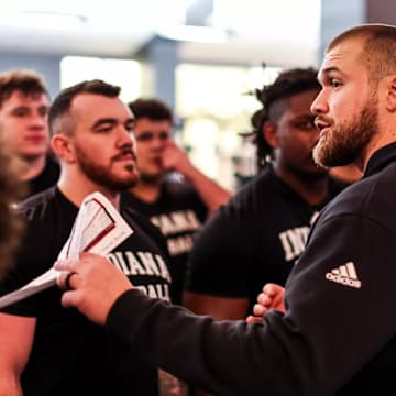 Indiana football director of athletic performance Derek Owings speaks to his players during a recent session in the Memorial Stadium weight room.