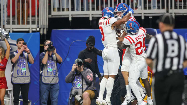 Dec 30, 2023; Atlanta, GA, USA; Mississippi Rebels tight end Caden Prieskorn (86) celebrates with wide receiver Tre Harris (9) and running back Ulysses Bentley IV (24) after a touchdown catch against the Penn State Nittany Lions in the first quarter at Mercedes-Benz Stadium. Mandatory Credit: Brett Davis-USA TODAY Sports