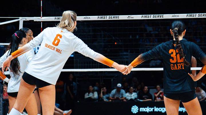 Abby Vander Wal holds hands with a teammate before a match at the First Serve Event. Abby Vander Wal holds hands with a teammate before a match at the First Serve Event.