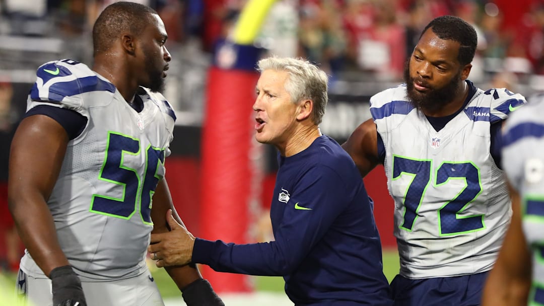 Oct 23, 2016; Glendale, AZ, USA; Seattle Seahawks defensive end Cliff Avril (56) and defensive end Michael Bennett (72) with head coach Pete Carroll against the Arizona Cardinals at University of Phoenix Stadium. The game ended in a 6-6 tie after overtime.
