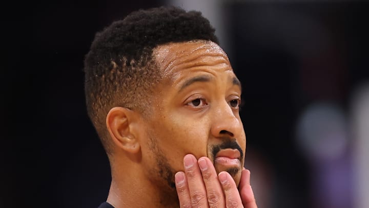 CJ McCollum clasps his hands on his face.