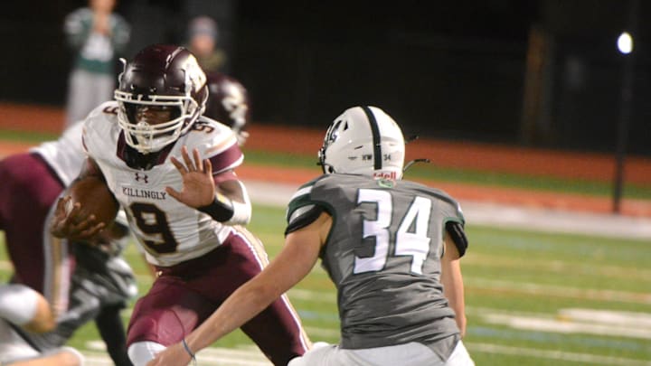 Killingly senior Everton Brown rushes past Guilford defender Bryce Perry during Killingly's 48-13 win Thursday night at Kavanaugh Field in Guilford. Killingly senior Everton Brown rushes past Guilford defender Bryce Perry during Killingly's 48-13 win Thursday night at Kavanaugh Field in Guilford.