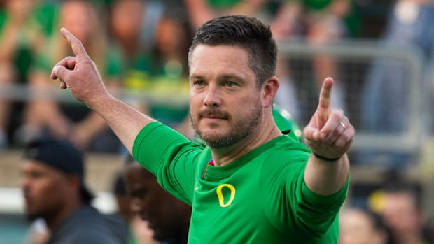 Oregon coach Dan Lanning oversees warmups before the game against Boise State at Autzen 