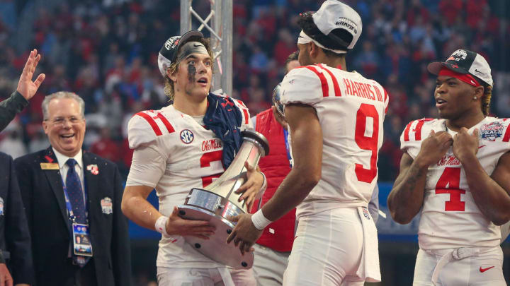 Dec 30, 2023; Atlanta, GA, USA; Mississippi Rebels quarterback Jaxson Dart (2) holds the Peach Bowl trophy as wide receiver Tre Harris (9) catches the top after a victory against the Penn State Nittany Lions at Mercedes-Benz Stadium. Mandatory Credit: Brett Davis-USA TODAY Sports
