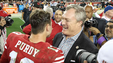 San Francisco 49ers quarterback Brock Purdy (L) and general manager John Lynch (R)