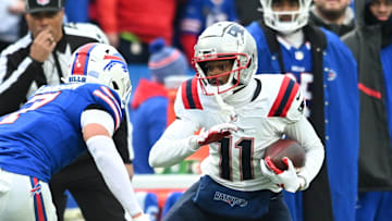 Dec 31, 2023; Orchard Park, New York, USA; New England Patriots wide receiver Tyquan Thornton (11) tries to move past Buffalo Bills cornerback Taron Johnson (7) after making a catch in the third quarter at Highmark Stadium. Mandatory Credit: Mark Konezny-USA TODAY Sports