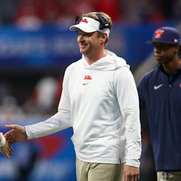 Dec 30, 2023; Atlanta, GA, USA; Mississippi Rebels head coach Lane Kiffin celebrates with quarterback Jaxson Dart (2) after a touchdown against the Penn State Nittany Lions in the second half at Mercedes-Benz Stadium. Mandatory Credit: Brett Davis-Imagn Images