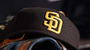 Jul 23, 2021; Miami, Florida, USA; A general view of a San Diego Padres hat and glove in the dugout prior to the game between the Miami Marlins and the San Diego Padres at loanDepot park.  