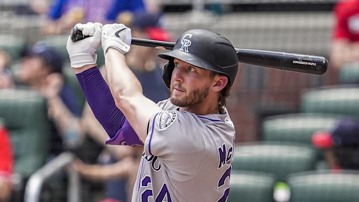 Jun 15, 2025; Cumberland, Georgia, USA; Colorado Rockies third baseman Ryan McMahon (24) hits a home run against the Atlanta Braves during the seventh inning at Truist Park. 