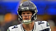 Seattle Seahawks quarterback Sam Darnold rolls out to pass during the first half against the Los Angeles Rams.