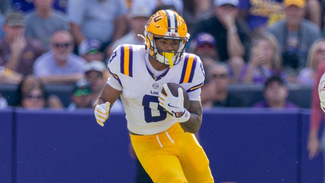 Nov 15, 2025; Baton Rouge, Louisiana, USA;  LSU Tigers running back Ju'Juan Johnson (8) runs against the Arkansas Razorbacks during the first half at Tiger Stadium. Mandatory Credit: Stephen Lew-Imagn Images