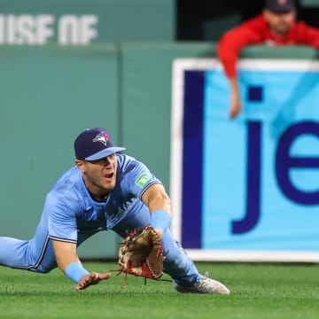 Aug 28, 2024; Boston, Massachusetts, USA; Toronto Blue Jays center fielder Daulton Varsho (25) attempts to catch a line drive during the seventh inning against the Boston Red Sox at Fenway Park.