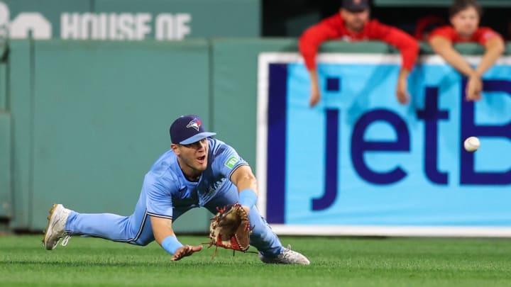 Aug 28, 2024; Boston, Massachusetts, USA; Toronto Blue Jays center fielder Daulton Varsho (25) attempts to catch a line drive during the seventh inning against the Boston Red Sox at Fenway Park.