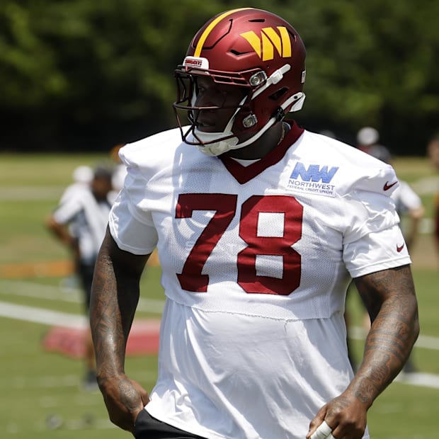 Washington Commanders offensive tackle Laremy Tunsil stands on the field on day one of minicamp