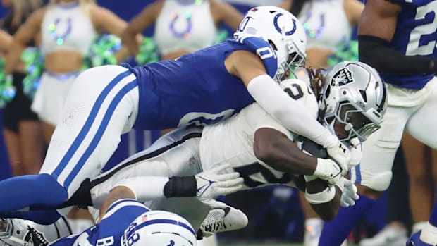 Indianapolis Colts safety Cam Bynum (0) tackles Las Vegas Raiders running back Ashton Jeanty (2)