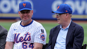 Jul 19, 2025; New York City, New York, USA; New York Mets manager Carlos Mendoza (64) talks to owner Steve Cohen (center) and his wife Alex Cohen (right) during the number retirement ceremony for former third baseman David Wright (not pictured) before a game against the Cincinnati Reds at Citi Field. Mandatory Credit: Brad Penner-Imagn Images