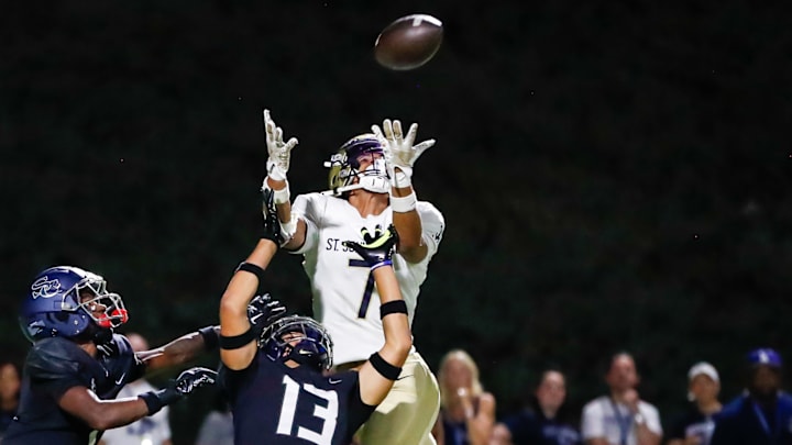 Receiver Madden Williams of St. John Bosco (Calif.) goes up for a pass over two Sierra Canyon defenders. Receiver Madden Williams of St. John Bosco (Calif.) goes up for a pass over two Sierra Canyon defenders.