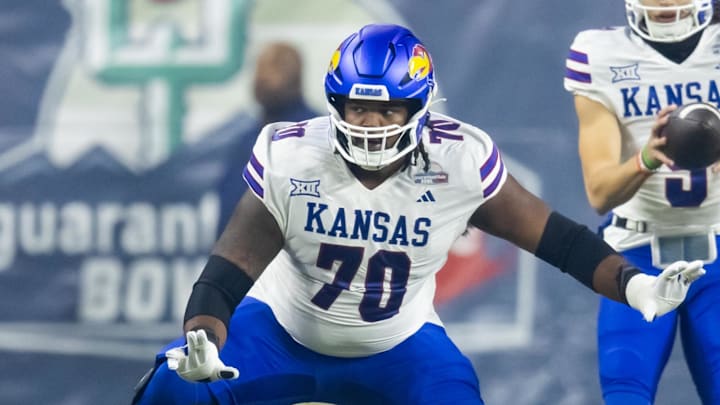Dec 26, 2023; Phoenix, AZ, USA; Kansas Jayhawks offensive lineman Kobe Baynes (70) against the UNLV Rebels in the Guaranteed Rate Bowl at Chase Field. Mandatory Credit: Mark J. Rebilas-USA TODAY Sports