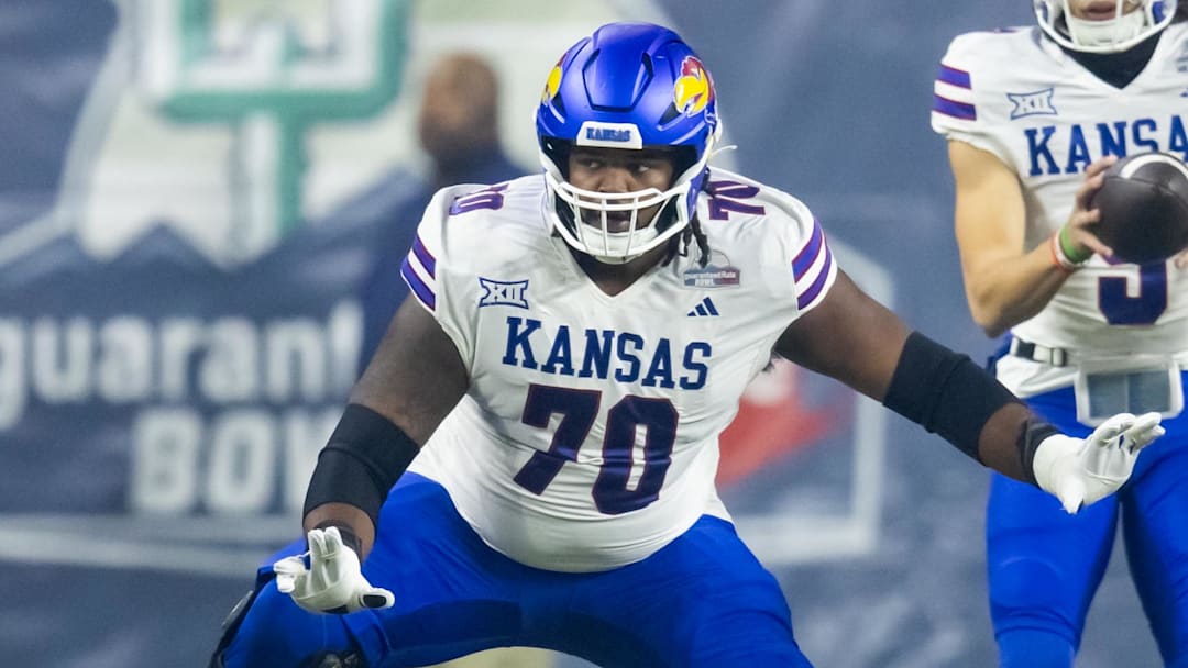 Dec 26, 2023; Phoenix, AZ, USA; Kansas Jayhawks offensive lineman Kobe Baynes (70) against the UNLV Rebels in the Guaranteed Rate Bowl at Chase Field. Mandatory Credit: Mark J. Rebilas-USA TODAY Sports