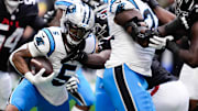 Nov 16, 2025; Atlanta, Georgia, USA; Carolina Panthers running back Rico Dowdle (5) runs with the ball in the second quarter against the Atlanta Falcons at Mercedes-Benz Stadium. 
