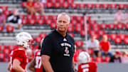 Aug 28, 2025; Raleigh, North Carolina, USA; North Carolina State Wolfpack head coach Dave Doeren walks among his players during the warmups prior to the game against East Carolina Pirates at Carter-Finley Stadium. Mandatory Credit: Jaylynn Nash-Imagn Images