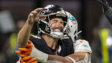 Oct 26, 2025; Atlanta, Georgia, USA; Atlanta Falcons quarterback Kirk Cousins (18) is hit by Miami Dolphins linebacker Jaelan Phillips (15) as he releases the ball during the first quarter at Mercedes-Benz Stadium. Mandatory Credit: Dale Zanine-Imagn Images