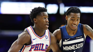 Oct 17, 2025; Philadelphia, Pennsylvania, USA; Philadelphia 76ers guard Vj Edgecombe (77) dribbles past Minnesota Timberwolves guard Rob Dillingham (4) during the third quarter at Xfinity Mobile Arena. Mandatory Credit: Bill Streicher-Imagn Images