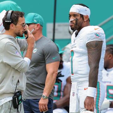 Miami Dolphins head coach Mike McDaniel and quarterback Tua Tagovailoa (1) stand on the sideline against the New England Patriots during the second quarter at Hard Rock Stadium.