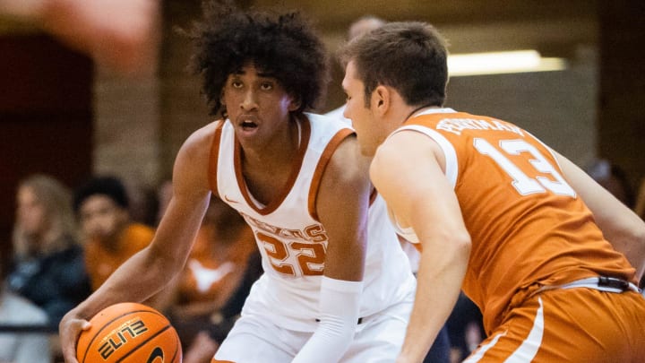 Texas forward Devon Pryor (22) looks for a pass to a White Team team mate as guard Gavin Perryman defends for the Orange Team during the annual Orange and White Game in the Gregory Gymnasium, Oct. 17, 2023.