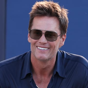 Aug 8, 2025; Foxborough, Massachusetts, USA; Retired New England Patriot Hall of Famer Tom Brady speaks during a statue unveiling before a game against the Washington Commanders at Gillette Stadium. Mandatory Credit: Paul Rutherford-Imagn Images