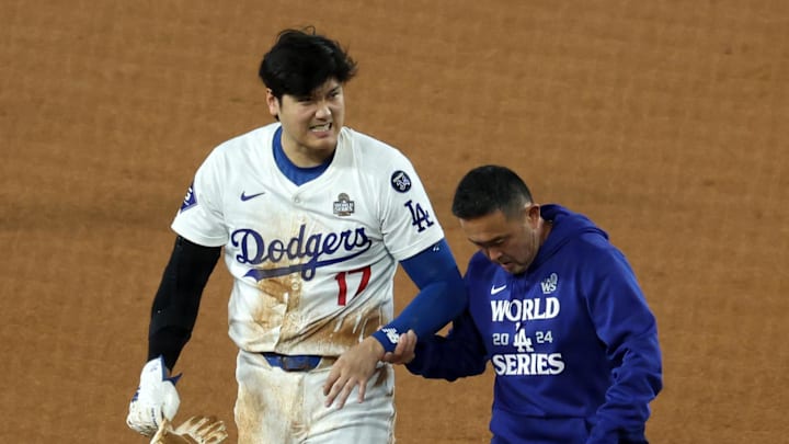 Oct 26, 2024; Los Angeles, California, USA; Los Angeles Dodgers designated hitter Shohei Ohtani (17) walks off the field after injuring his shoulder against the New York Yankees in the seventh inning for game two of the 2024 MLB World Series at Dodger Stadium. Mandatory Credit: Kiyoshi Mio-Imagn Images
