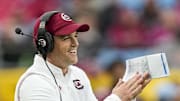 Dec 30, 2021; Charlotte, NC, USA; South Carolina Gamecocks head coach Shane Beamer cheers on his defense during the second half against the North Carolina Tar Heels at Bank of America Stadium. Mandatory Credit: Jim Dedmon-Imagn Images