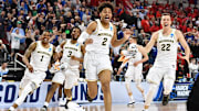 Michigan's Jordan Poole (2) celebrates after making a buzzer-beating shot to defeat Houston in the second round of the 2018 NCAA Tournament
