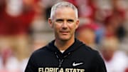 Nov 29, 2025; Gainesville, Florida, USA; Florida State Seminoles head coach Mike Norvell walks on the field before a game against the Florida Gators at Ben Hill Griffin Stadium. Mandatory Credit: Matt Pendleton-Imagn Images