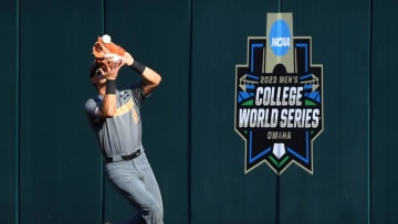 Tennessee outfielder Hunter Ensley (9) catches a ball hit by LSU outfielder Dylan Crews (3) at the wall during a NCAA College World Series elimination game between Tennessee and LSU at Charles Schwab Field in Omaha, Neb. on Tuesday, June 20, 2023.