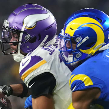 Los Angeles Rams safety Quentin Lake (37) tackles Minnesota Vikings receiver Justin Jefferson (18) during their playoff game at State Farm Stadium on Jan. 13, 2025, in Glendale.