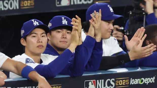 Hyeseong Kim, Yoshinobu Yamamoto and Shohei Ohtani in the dugout
