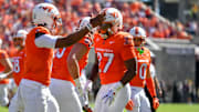 Oct 4, 2025; Blacksburg, Va.; Virginia Tech running back Marcellous Hawkins (27) celebrates with quarterback Kyron Drones (1).