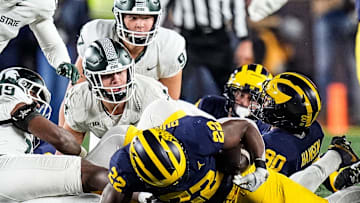 Michigan running back Tavierre Dunlap (22) picks up the ball after Michigan State's onsite kick during the second half at Michigan Stadium in Ann Arbor on Saturday, Oct. 26, 2024.