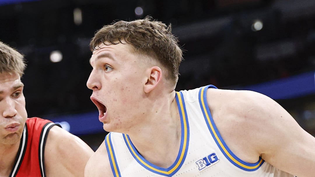 Mar 12, 2026; Chicago, IL, USA; UCLA Bruins forward Tyler Bilodeau (34) drives to the basket against Rutgers Scarlet Knights guard Harun Zrno (13) during the second half at United Center. Mandatory Credit: Kamil Krzaczynski-Imagn Images