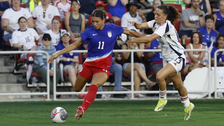 Jul 16, 2024; Washington, D.C., USA; United States forward Sophia Smith (11) crosses the ball as Costa Rica midfielder Emilie Valenciano (13) defends in the first half in the first half of a send-off friendly at Audi Field. Mandatory Credit: Geoff Burke-USA TODAY