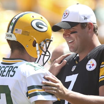 Aug 23, 2015; Pittsburgh, PA, USA; Green Bay Packers quarterback Aaron Rodgers (12) and Pittsburgh Steelers quarterback Ben Roethlisberger (7) talk at mid-field before their game at Heinz Field. Mandatory Credit: Charles LeClaire-Imagn Images