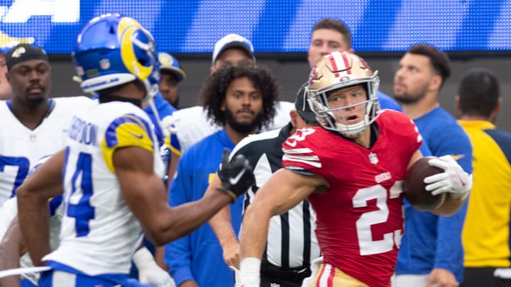 San Francisco 49ers running back Christian McCaffrey (R) and Los Angeles Rams cornerback Ahkello Witherspoon (L)